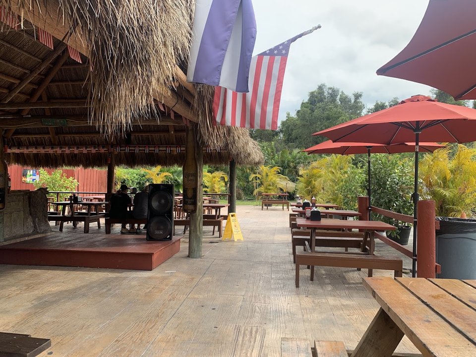 Outdoor picnic tables beside a barbecue restaurant.